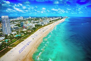 Una spiaggia nelle vicinanze, sabbia bianca, lettini da mare, ombrelloni