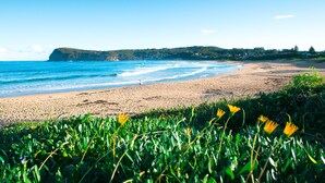 A beach with a clear view of the ocean and a distant hill. - Copacabana Shores (Copacabana)