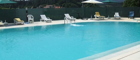 Seasonal outdoor pool, open 9:00 AM to 7:30 PM, pool umbrellas