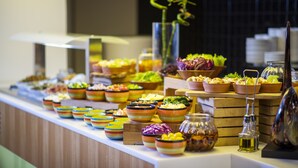A buffet with various dishes and condiments.