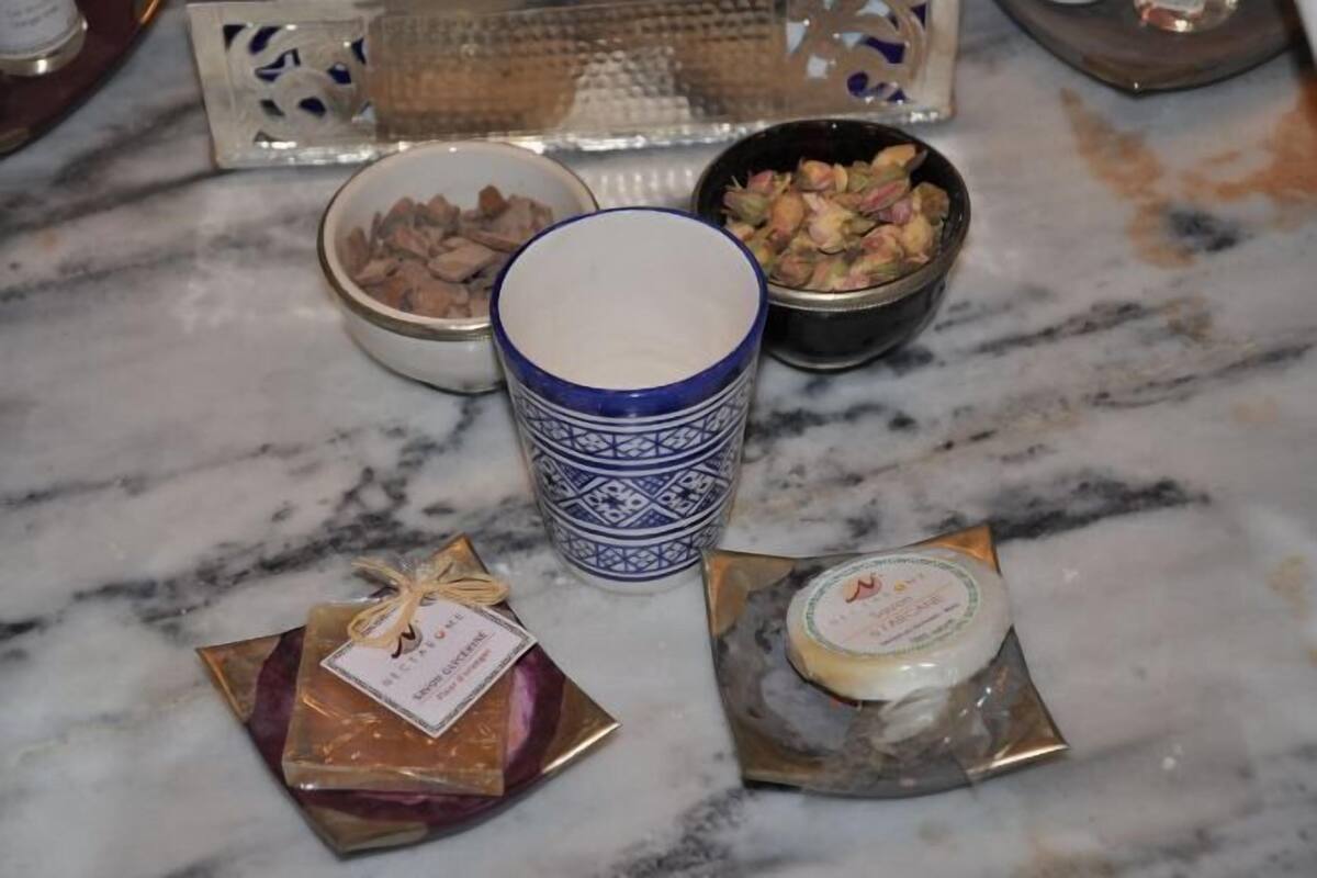 A marble countertop with a blue and white patterned cup, two small gift bags, and two bowls containing food items.