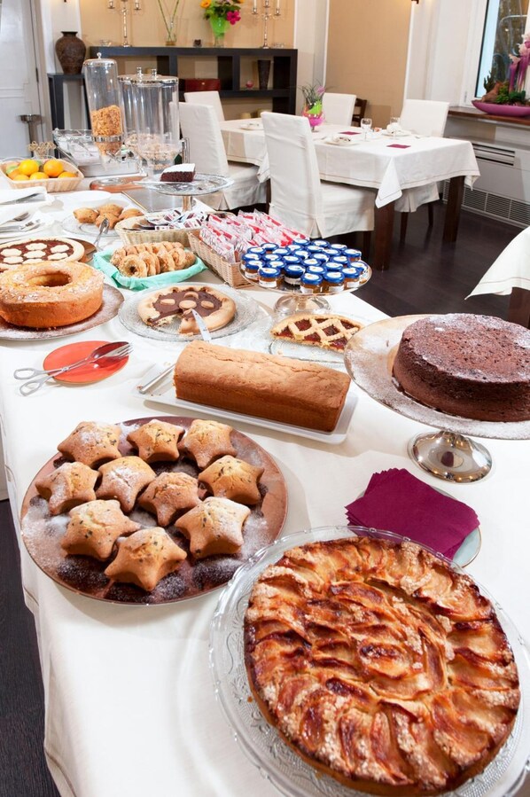 Una mesa de buffet con diversos postres y pasteles.
