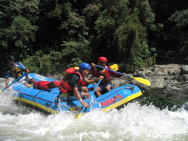 A group of people in a blue raft navigating a river. - Los Establos Boutique Resort- All Inclusive- Tours Included (Jaramillo)