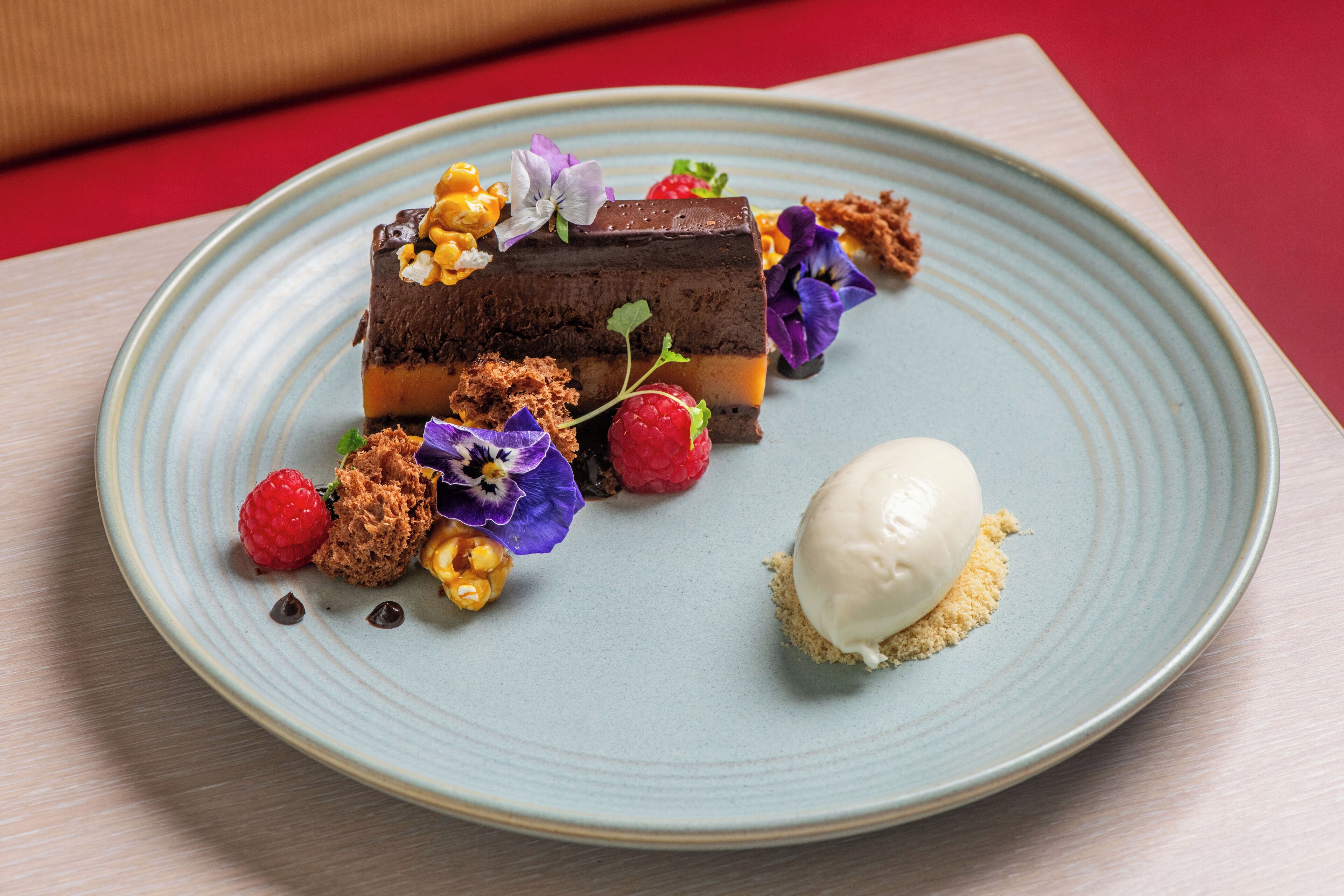 A dessert on a plate with a scoop of ice cream.