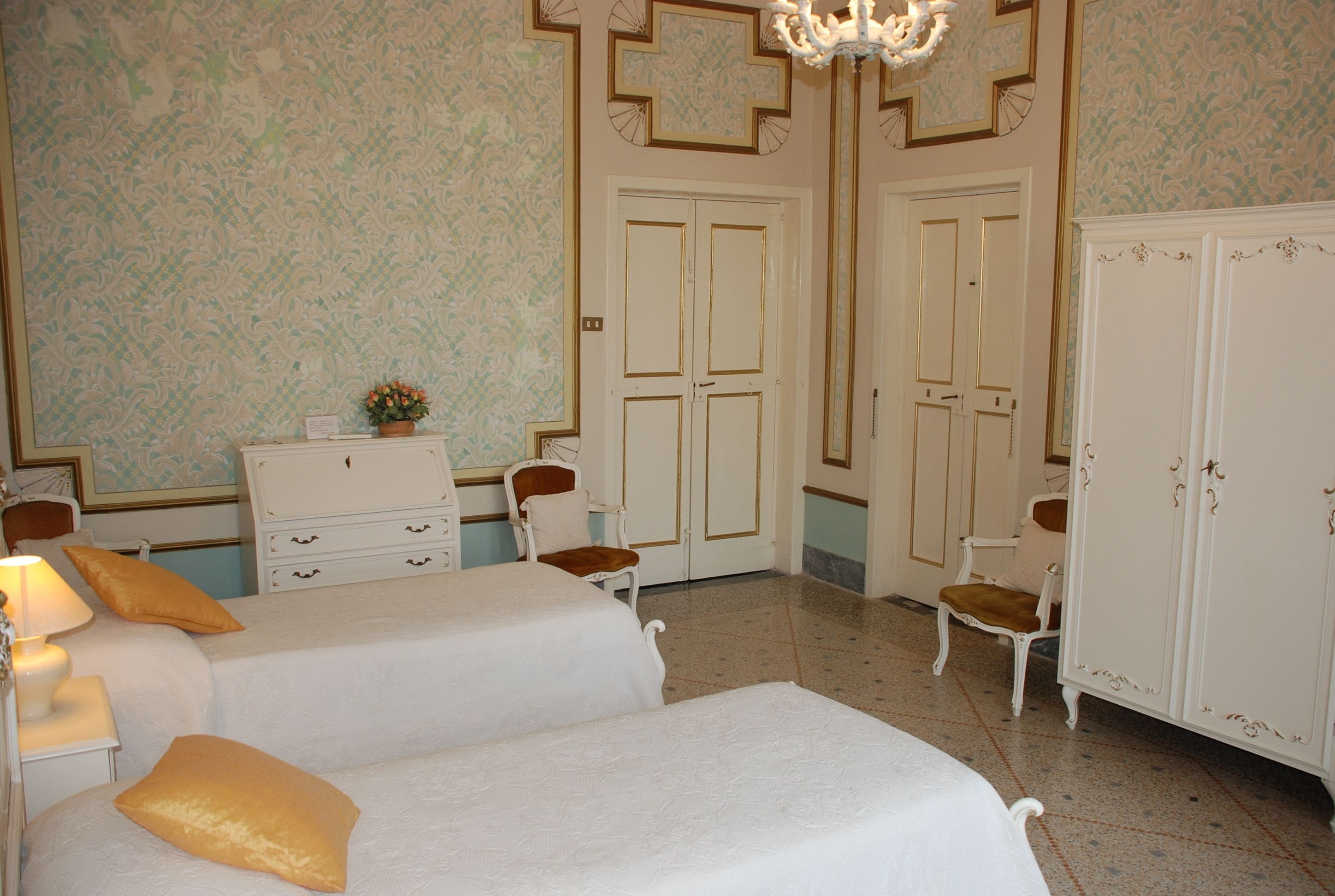 Een hotelkamer met twee bedden, een dressoir, een stoel en een kledingkast.
