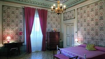 A room with a bed, a desk, a dresser, and a chair.
