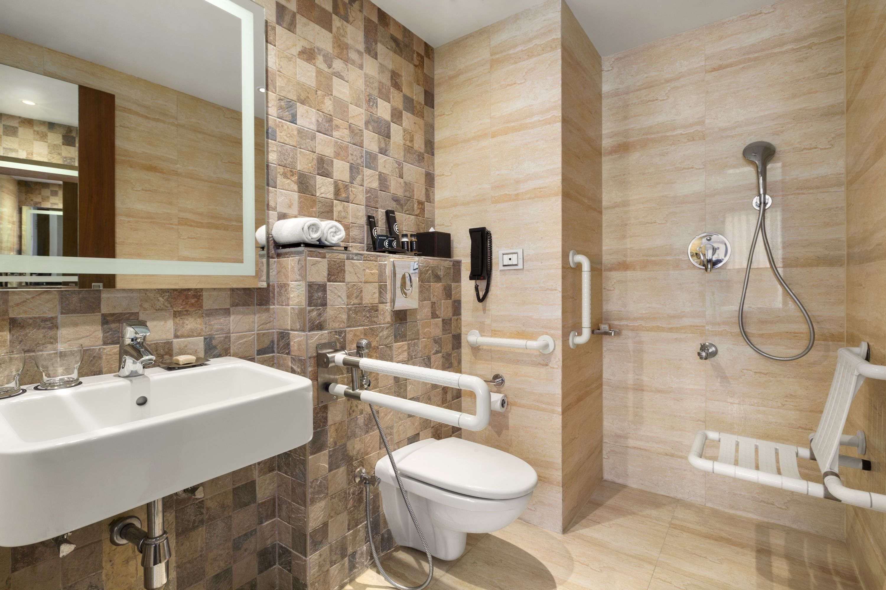 A modern bathroom with a sink, toilet, and shower.