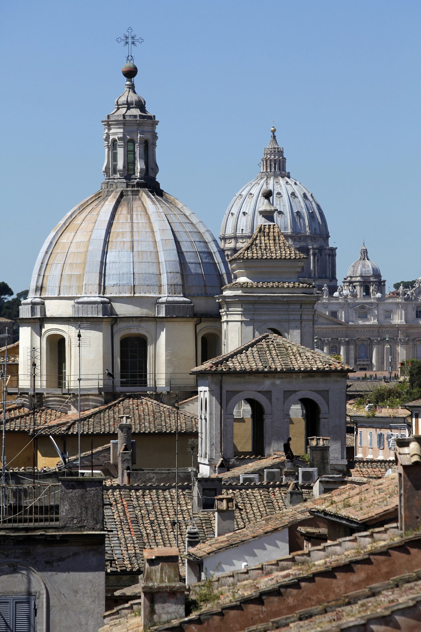A historic building with a large dome and smaller domes, surrounded by traditional rooftops.