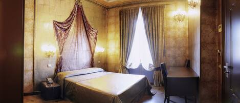 A luxurious bedroom with a large bed, a desk, and a chair.
