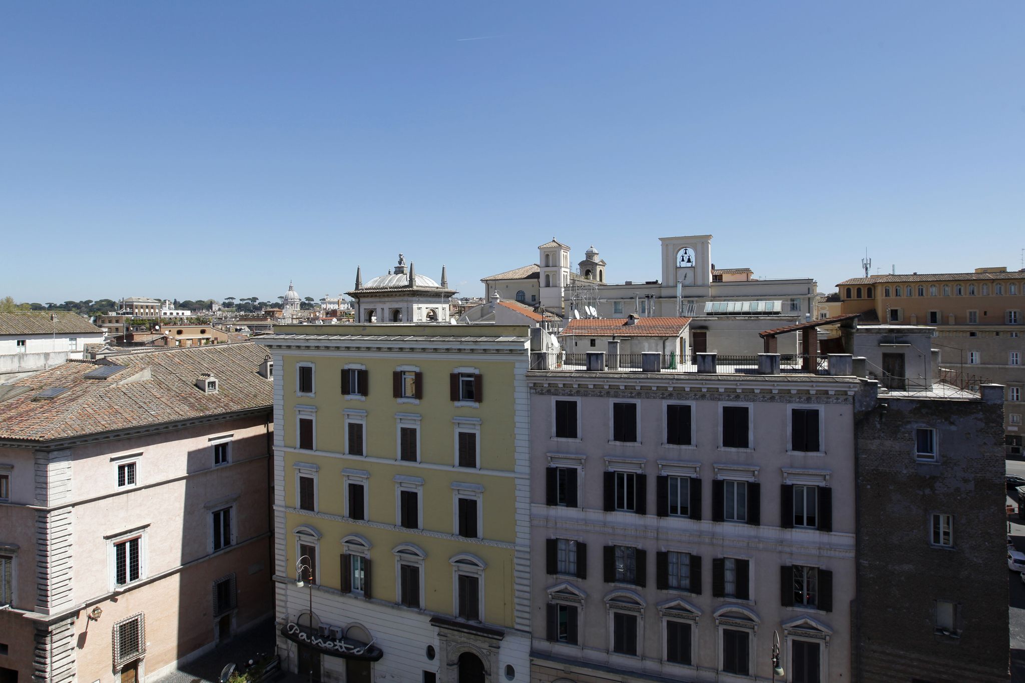A multi-story building with a mix of architectural styles, including a prominent dome and a bell tower.