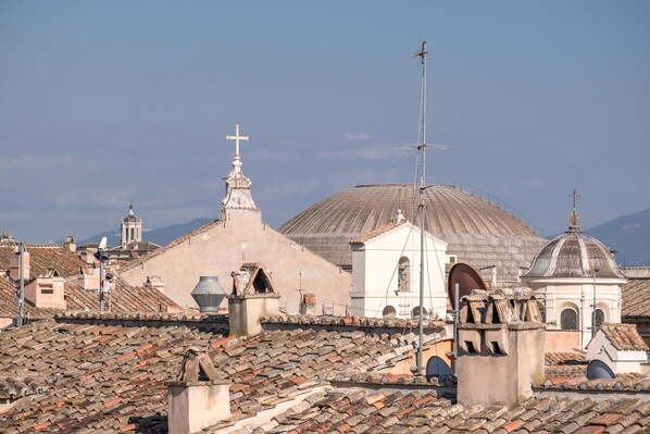 A historic cityscape with domed buildings and tiled rooftops. - Antica Dimora Delle Cinque Lune (Rome)