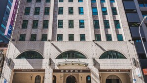 A multi-story hotel with a classic architectural design, featuring a prominent entrance with arched windows and signage for the Waikoloa Hotel. - Waikoloa Hotel (Taipei)