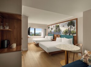A hotel room with two beds, a dining table, a coffee maker, and a view of the city. - Courtyard By Marriott Darwin (Darwin)