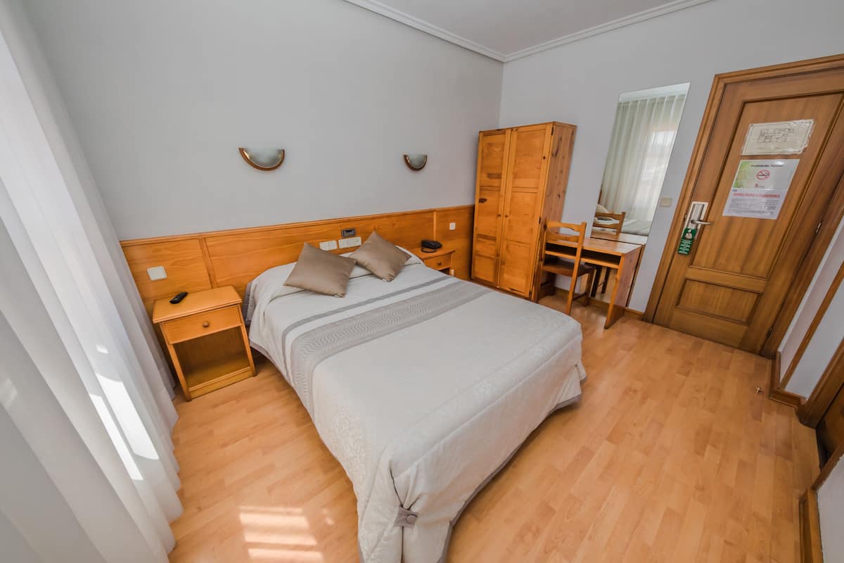 Double Room | Desk, blackout drapes, iron/ironing board (on request), travel crib