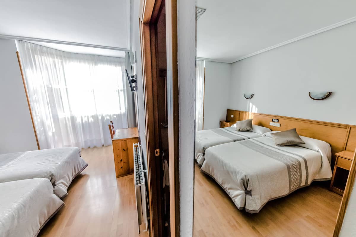 Twin Room | Desk, blackout drapes, iron/ironing board (on request), travel crib