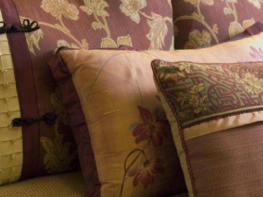 A close-up of a sofa with patterned cushions.