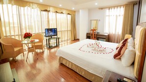 A hotel room with a large bed, a TV, a desk, and a chair. - Van Mieu 2 Hotel (Hanoi)