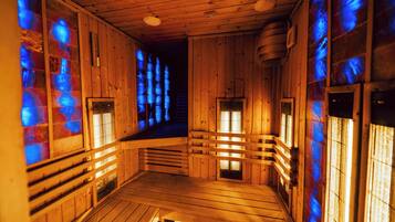 A wooden sauna with benches and glass windows.