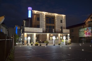 A hotel with a modern facade, a prominent neon sign, and a well-lit entrance. - Agit Hotel Congress & Spa (Lublin)