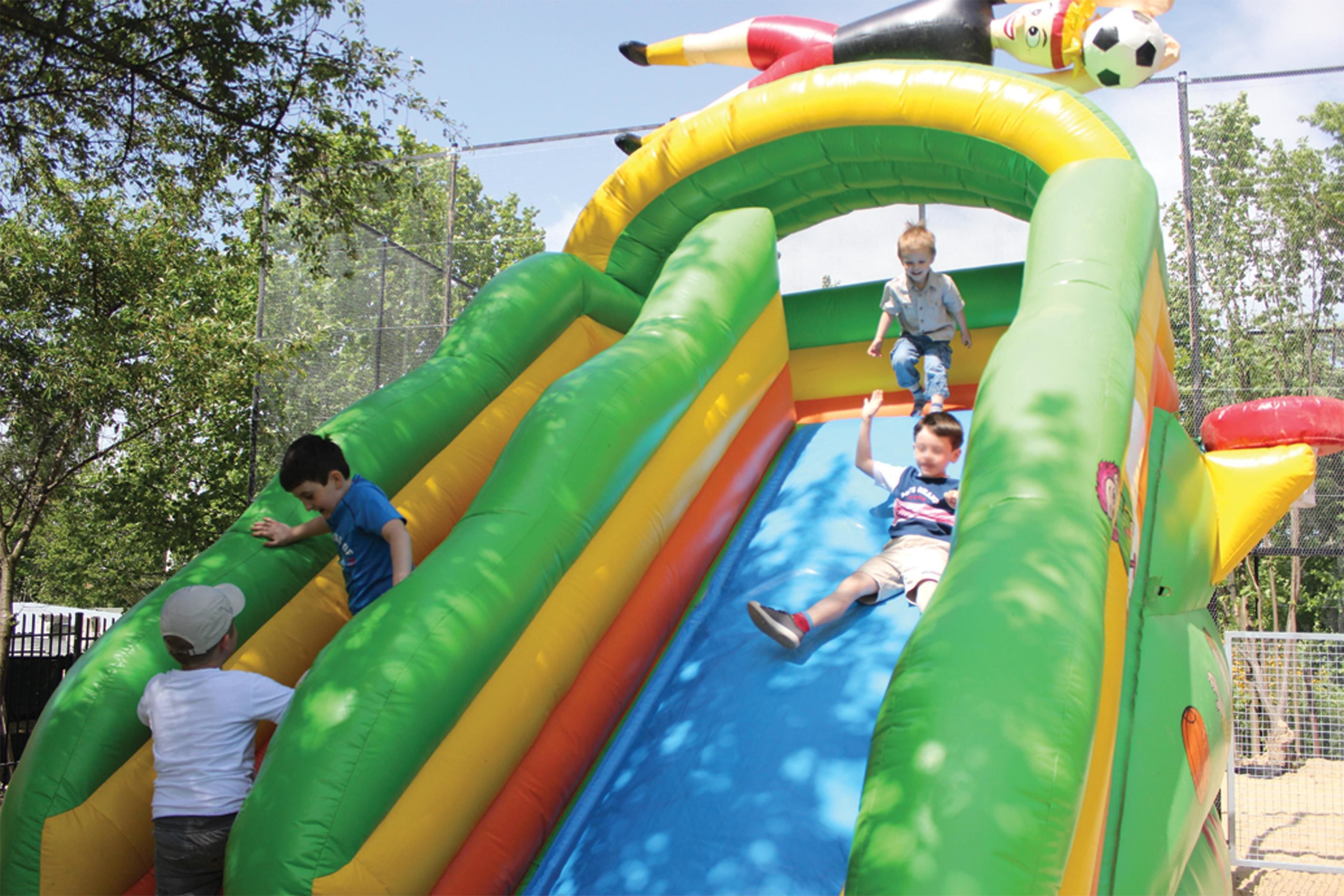 An inflatable play structure with slides and climbing areas.