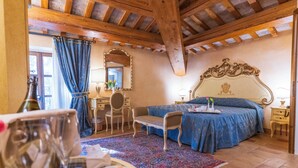 A bedroom with a bed, a desk, a chair, a window with curtains, and a wooden ceiling. - Villa Rinalducci (Fano)