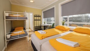 A room with bunk beds, a desk, and a large window. - Hostel B47 (Reykjavik)