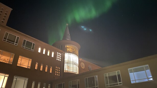 A building with multiple windows and a tower with a spire. - Hostel B47 (Reykjavik)