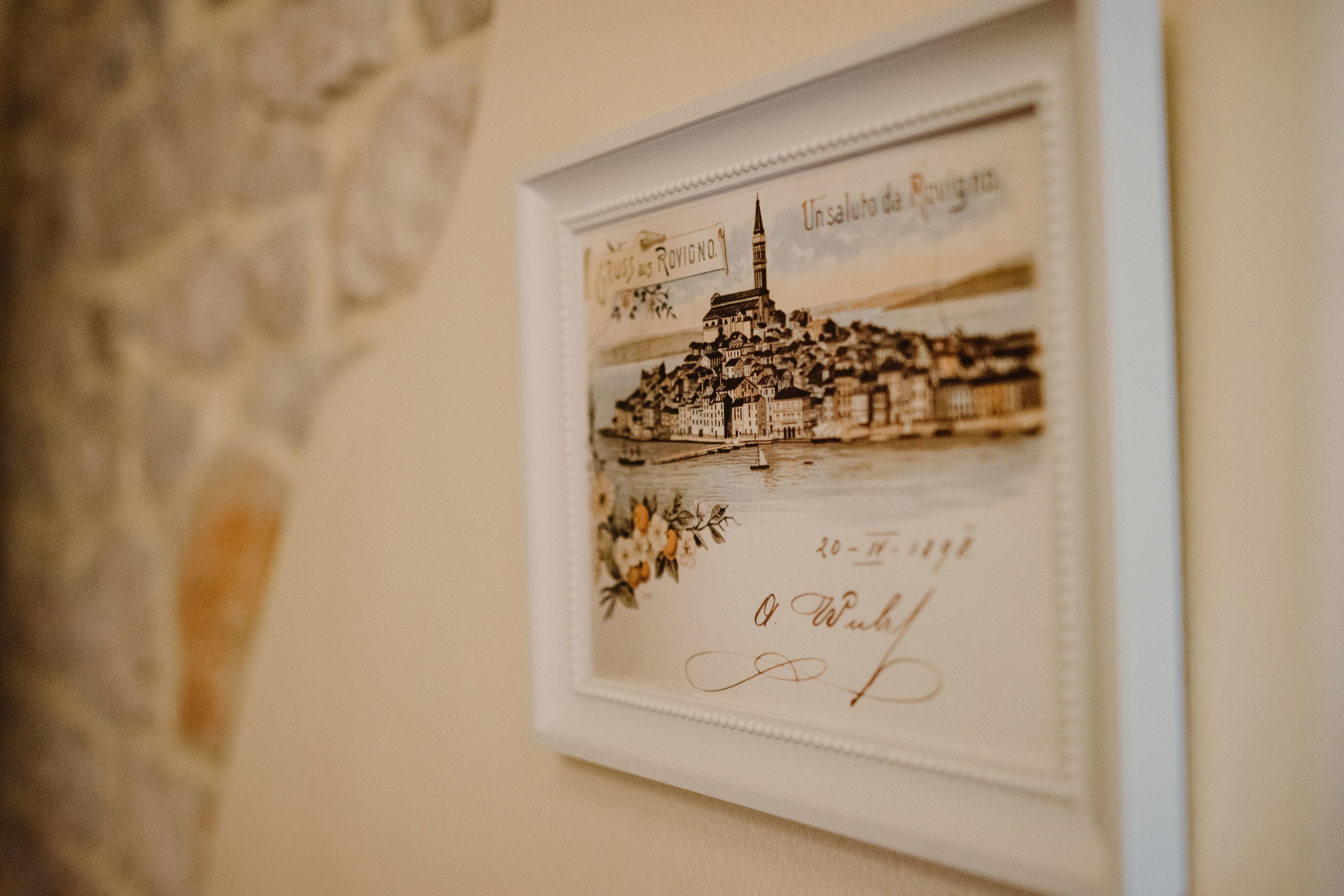 A framed historical illustration of a town with a prominent tower, signed by O. Wulff, dated 20-11-1911.