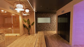 A modern interior with wooden flooring, a large potted plant, and a flat-screen TV mounted on the wall.