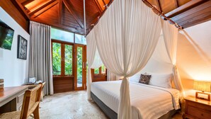 A bedroom with a canopy bed, wooden furniture, and a view of greenery outside. - S Resorts Hidden Valley Bali (Pecatu)
