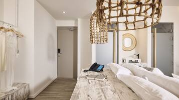 Relax in a serene space with a neatly made bed, wooden bedside table, and a unique light fixture.