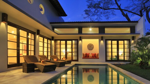 A modern house with a swimming pool, large windows, and outdoor seating. - Destiny Villas and Residence Seminyak (Keroboken Kelod)