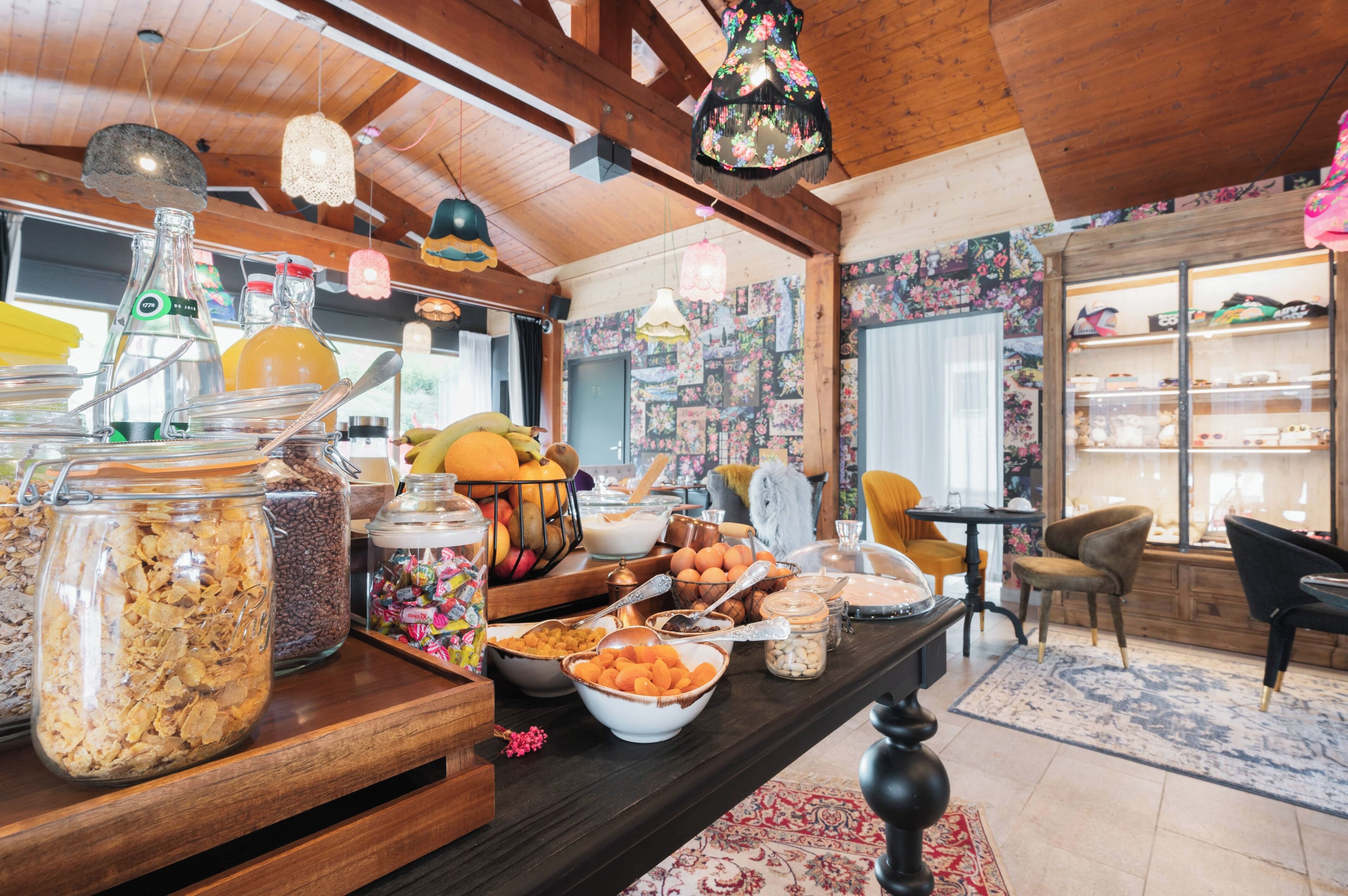 A buffet table with various food items and a wooden interior.