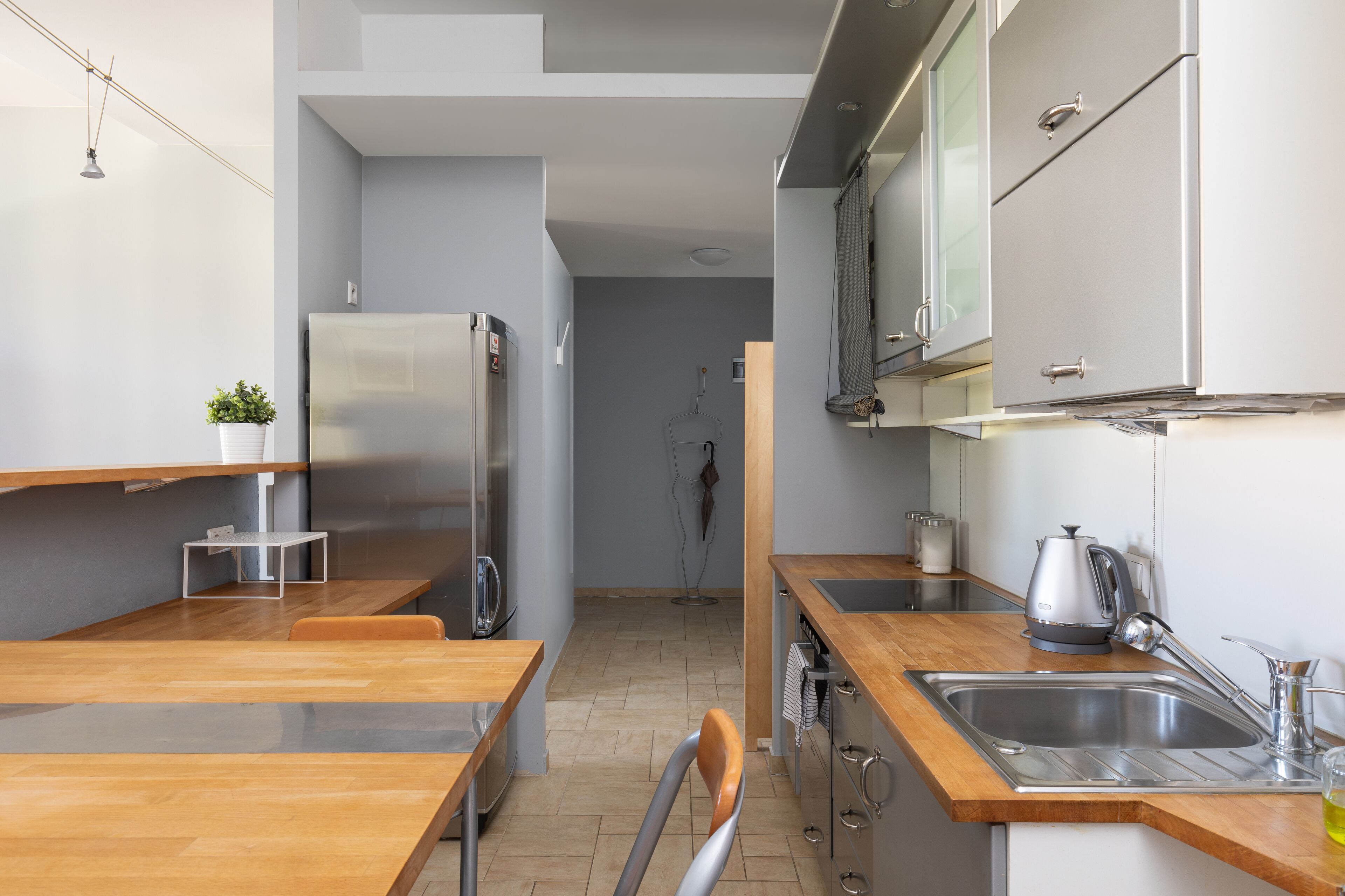 A modern kitchen with wooden countertops, stainless steel appliances, and a visible sink.