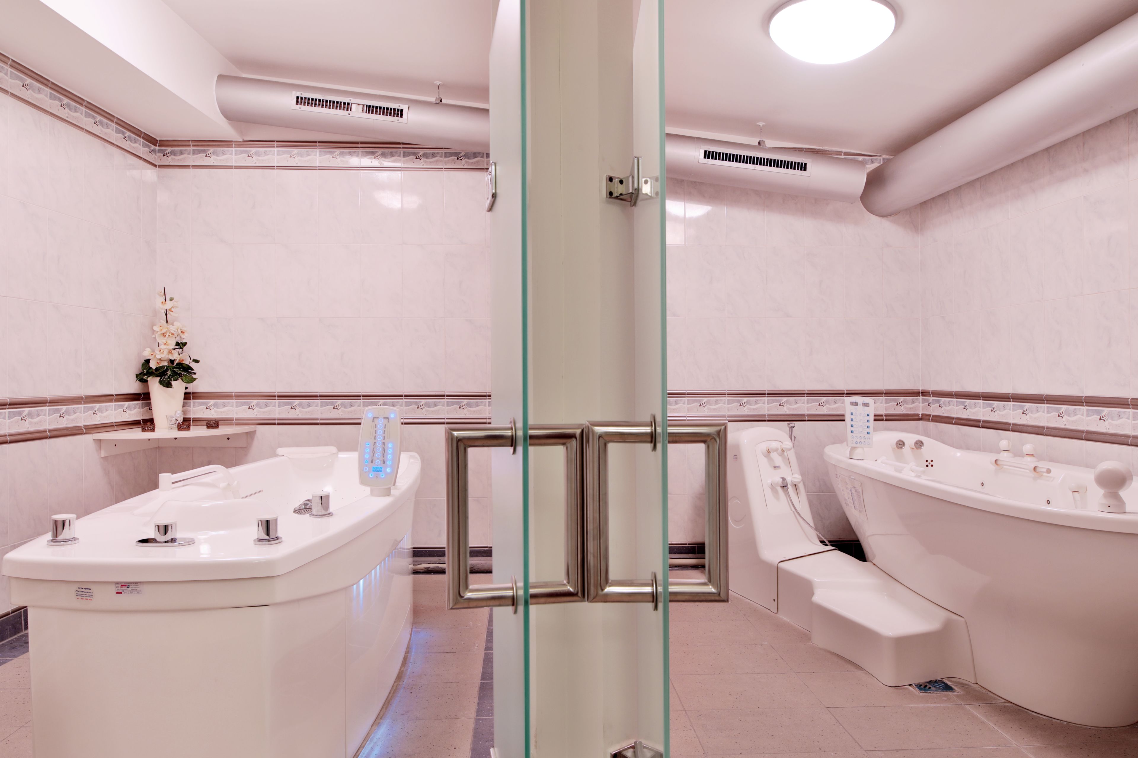 A modern bathroom with a freestanding bathtub, a separate shower area, and a vanity with a sink.