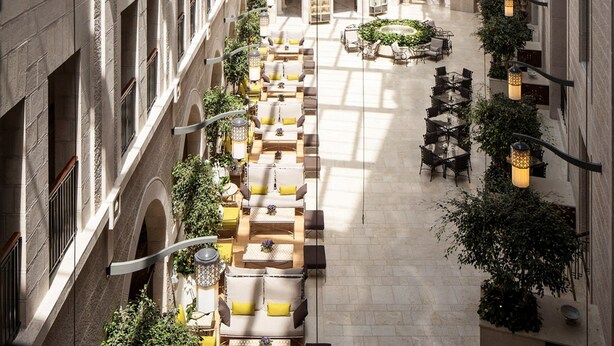 A spacious atrium with a high ceiling, multiple levels of seating areas, and a central open space. - Waldorf Astoria Jerusalem (Jerusalem)