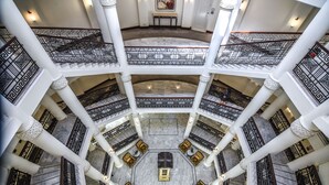 A multi-level atrium with marble flooring, ornate railings, and a central seating area. - Waldorf Astoria Jerusalem (Jerusalem)