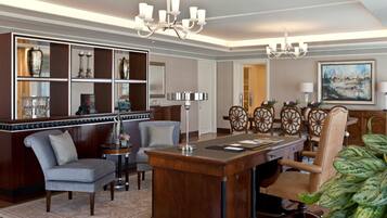 A well-appointed office with a desk, chairs, a bookshelf, and a large painting on the wall.