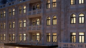 A multi-story building with arched windows and balconies, featuring a classical architectural style. - Waldorf Astoria Jerusalem (Jerusalem)