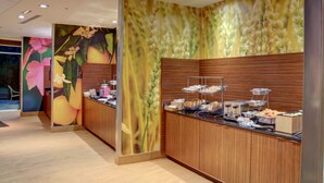 A buffet area with wooden paneling and a mural of wheat. - Fairfield Inn & Suites Natchitoches (Natchitoches)