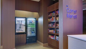 A corner market with a refrigerated display and shelves stocked with snacks and beverages. - Fairfield Inn & Suites Natchitoches (Natchitoches)