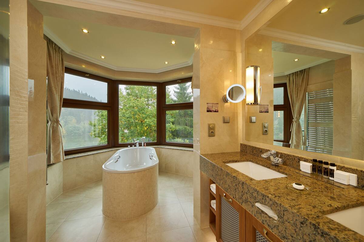 deluxe suite, balcony, river view | bathroom | shower, hydromassage showerhead, designer toiletries, hair dryer