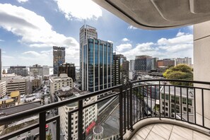 A high-rise building with a modern glass facade, a view of the cityscape, and a balcony railing. - Avani Auckland Metropolis Residences (Auckland)