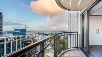 A balcony with a view of a cityscape, including a building with an 'AIG' sign.