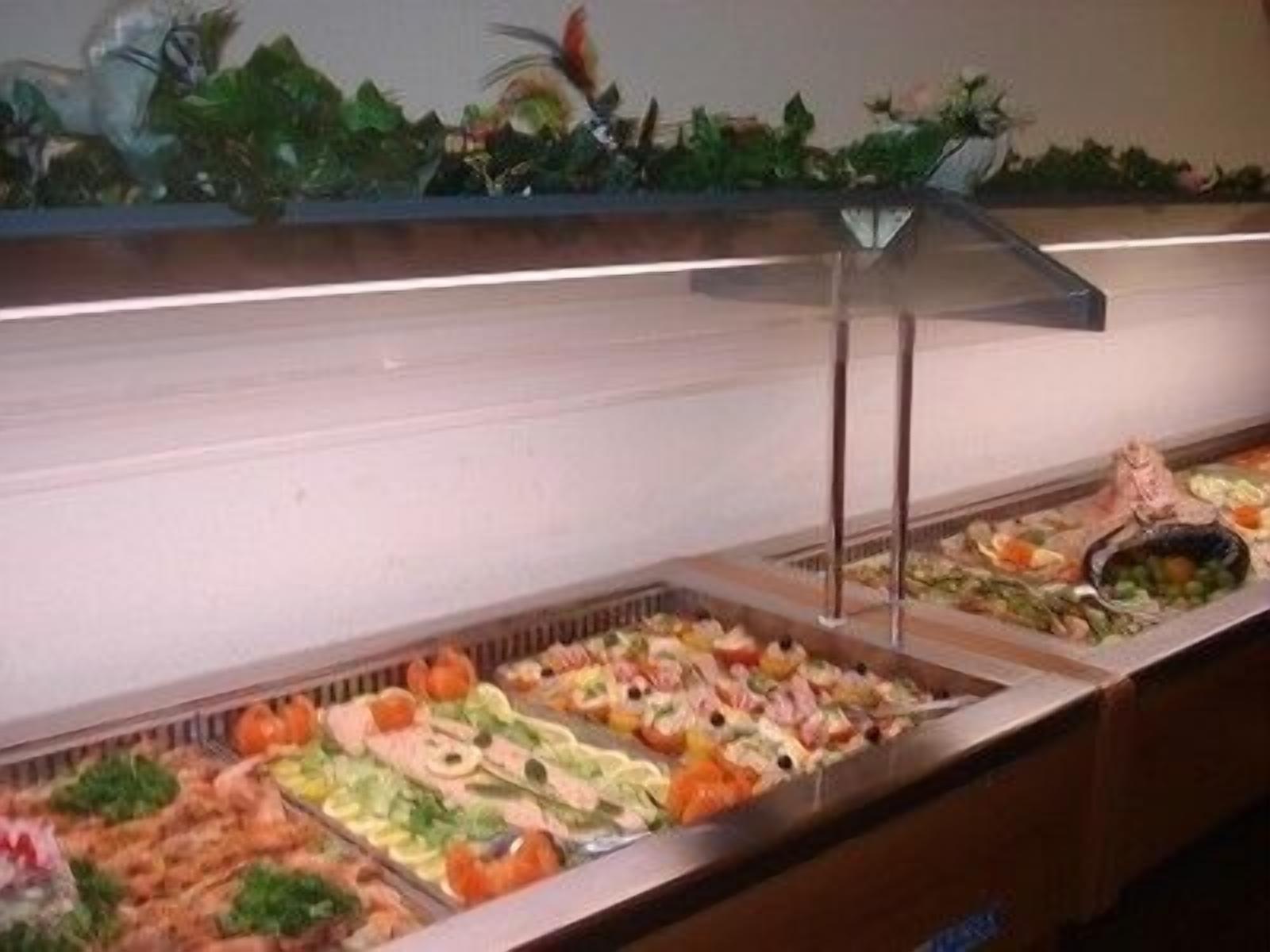 A buffet with various food items including seafood, vegetables, and salads.