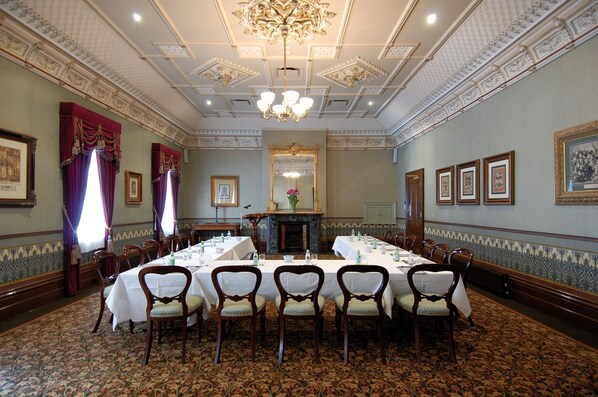 A formal dining room with a long table, ornate ceiling, and classic chairs. - Craig's Royal Hotel (Ballarat)