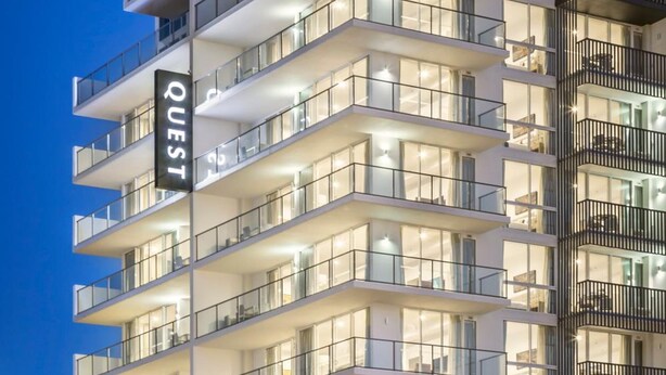A multi-story hotel with balconies, large windows, and a prominent sign. - Quest Mackay on Gordon (Mackay)