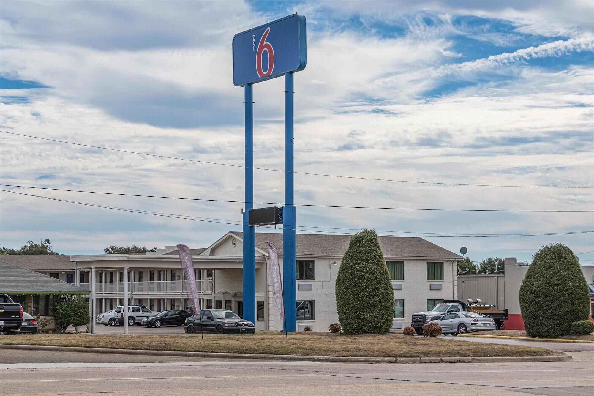 A motel with a large sign indicating room number 6.