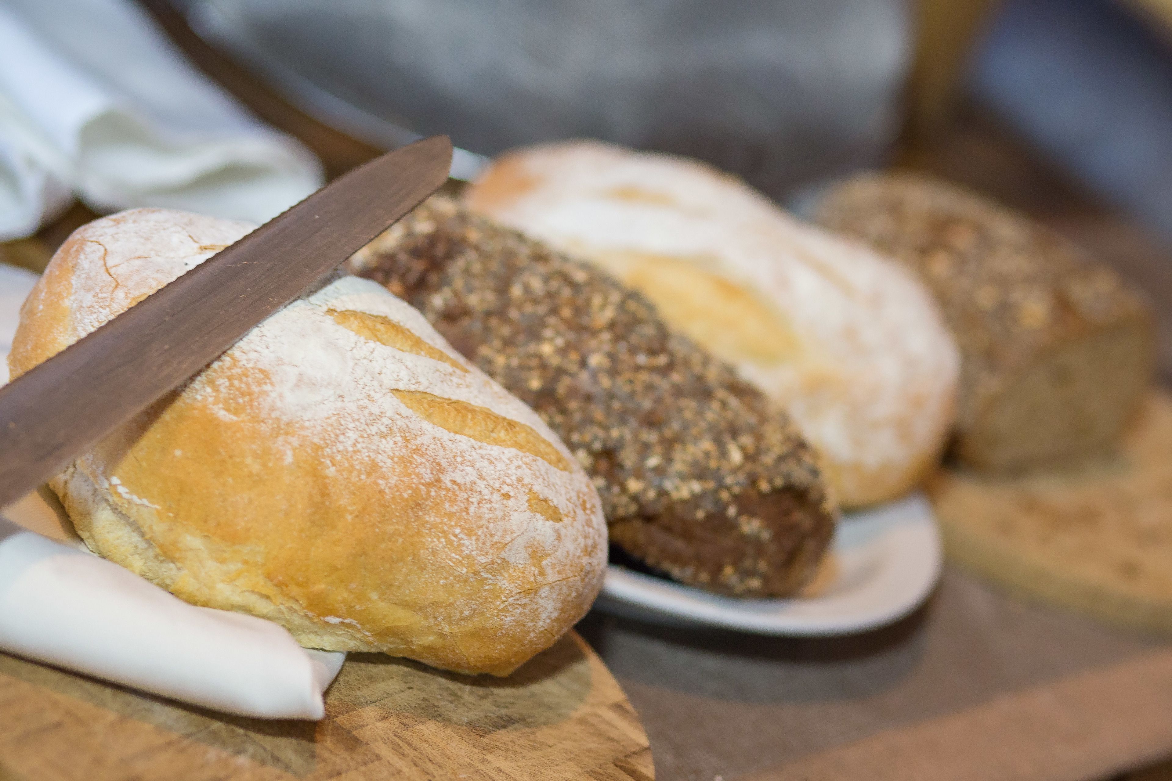 A variety of breads on a wooden board.