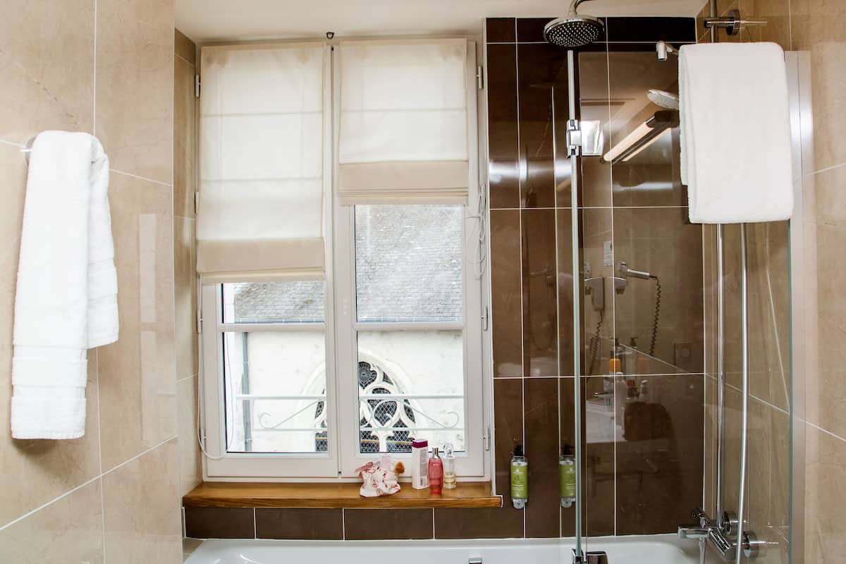 deluxe room | bathroom | rainfall showerhead, hair dryer, towels